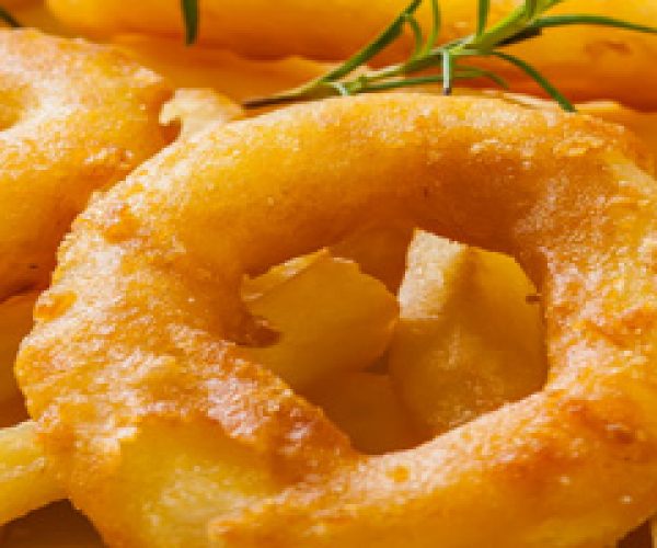 french fries with calamari and rosemary on white paper